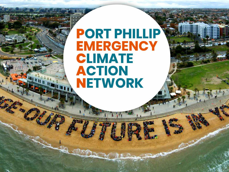 Port Phillip Emergency Climate Action Network banner image showing an aerial view of St Kilda with a human sign on the beach reading 'Climate change - Our future is in our hands'